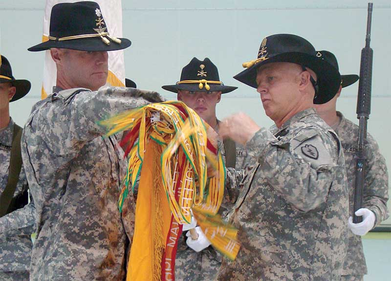 Lt. Col. Nicholas Snelson (left) and Command Sgt. Maj. Scott Bailey uncase the squadron colors at the redeployment ceremony for 6th Squadron, 17th Cavalry Regiment, Aug. 19. 