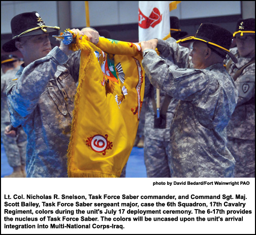 Lt. Col. Nicholas R. Snelson, Task Force Saber commander, and Command Sgt. Maj. Scott Bailey, Task Force Saber sergeant major, case the 6th Squadron, 17th Cavalry Regiment, colors during the unit's July 17 deployment ceremony.